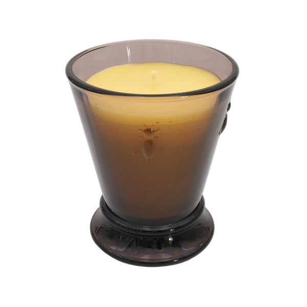 Bienenwachskerze im violetten Glas